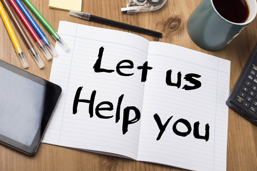 Let us Help you - Note Pad With Text Let us Help you - Note Pad With Text On Wooden Table - with office tools