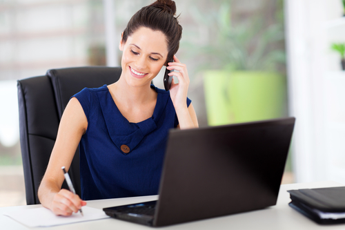 cute young office worker cute young office worker talking on cell phone in office